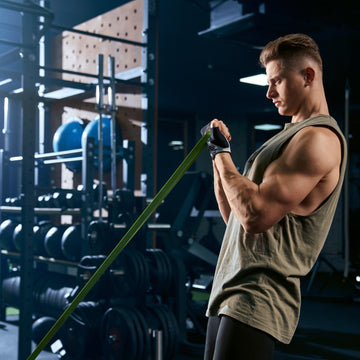 Man exercising with resistance bands in a gym setting